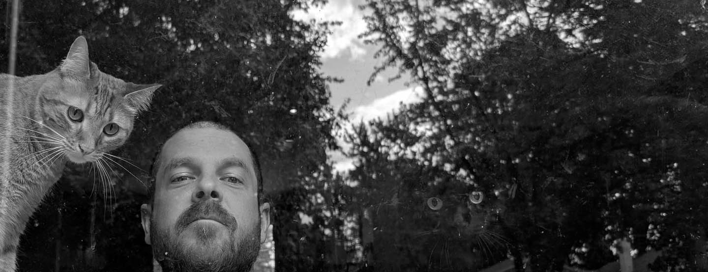 Mike with his two feline supervisors in a black and white collage